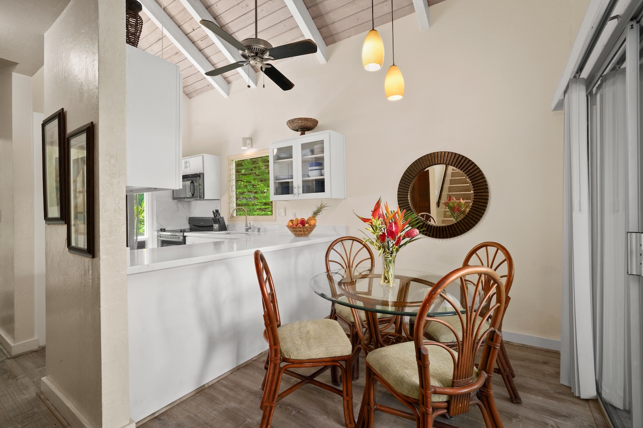 2330 Ho'ohu Road, Unit 27 Koloa, HI 96756 - Photo 9 of 30 a dining room with furniture and a chandelier fan