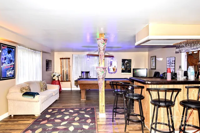 a living room with furniture a chandelier and a dining table