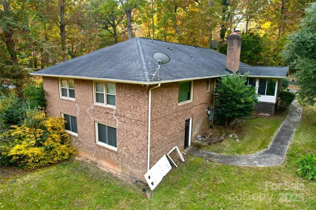 a aerial view of a house with a yard table and chairs