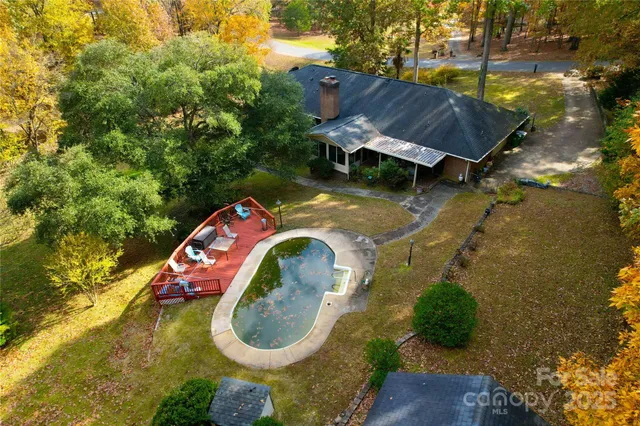 an aerial view of a house with swimming pool and outdoor space