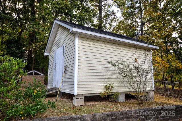 a view of a house with a yard and tree s