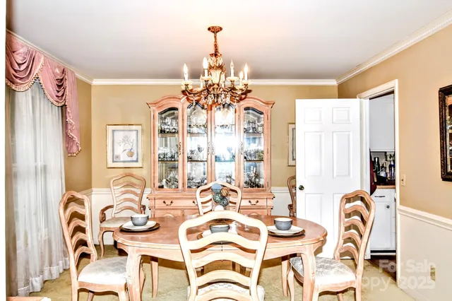 a view of a dining room with furniture and chandelier
