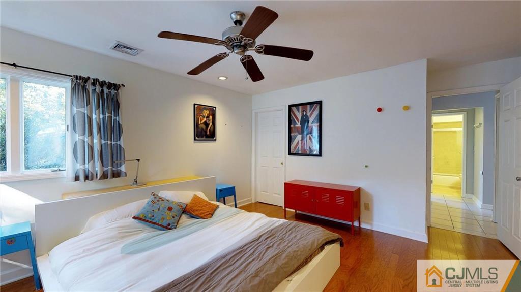 27 Springdale Road Kendall Park, NJ 08824 - Photo 14 of 25 a bedroom with a bed and wooden floor
