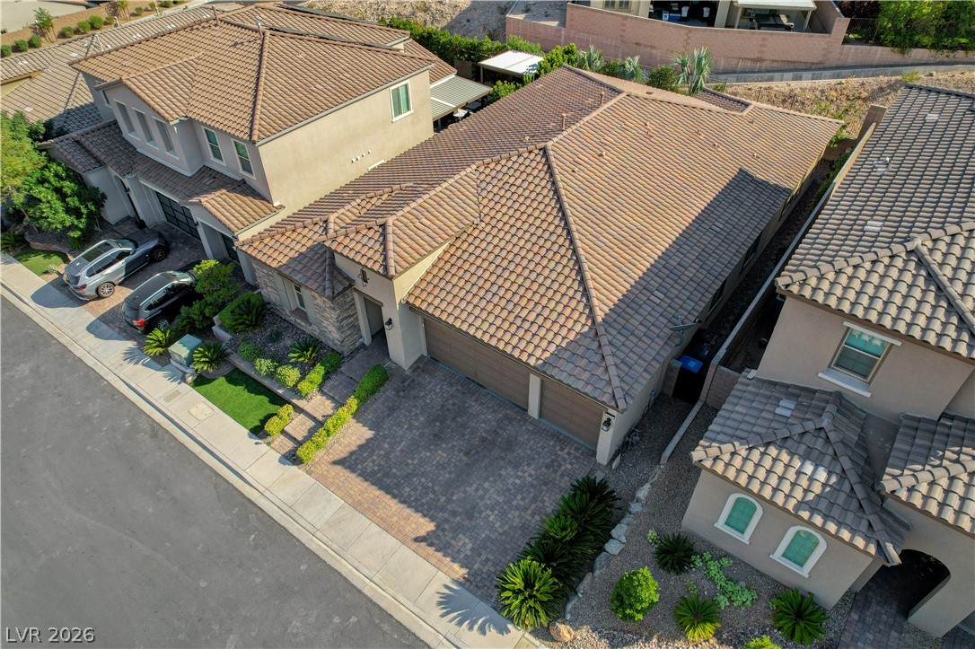 3943 Reyes Avenue Las Vegas, NV 89141 - Photo 80 of 95 An aerial perspective reveals a tiled roof and paver driveway, presenting a well-maintained property.