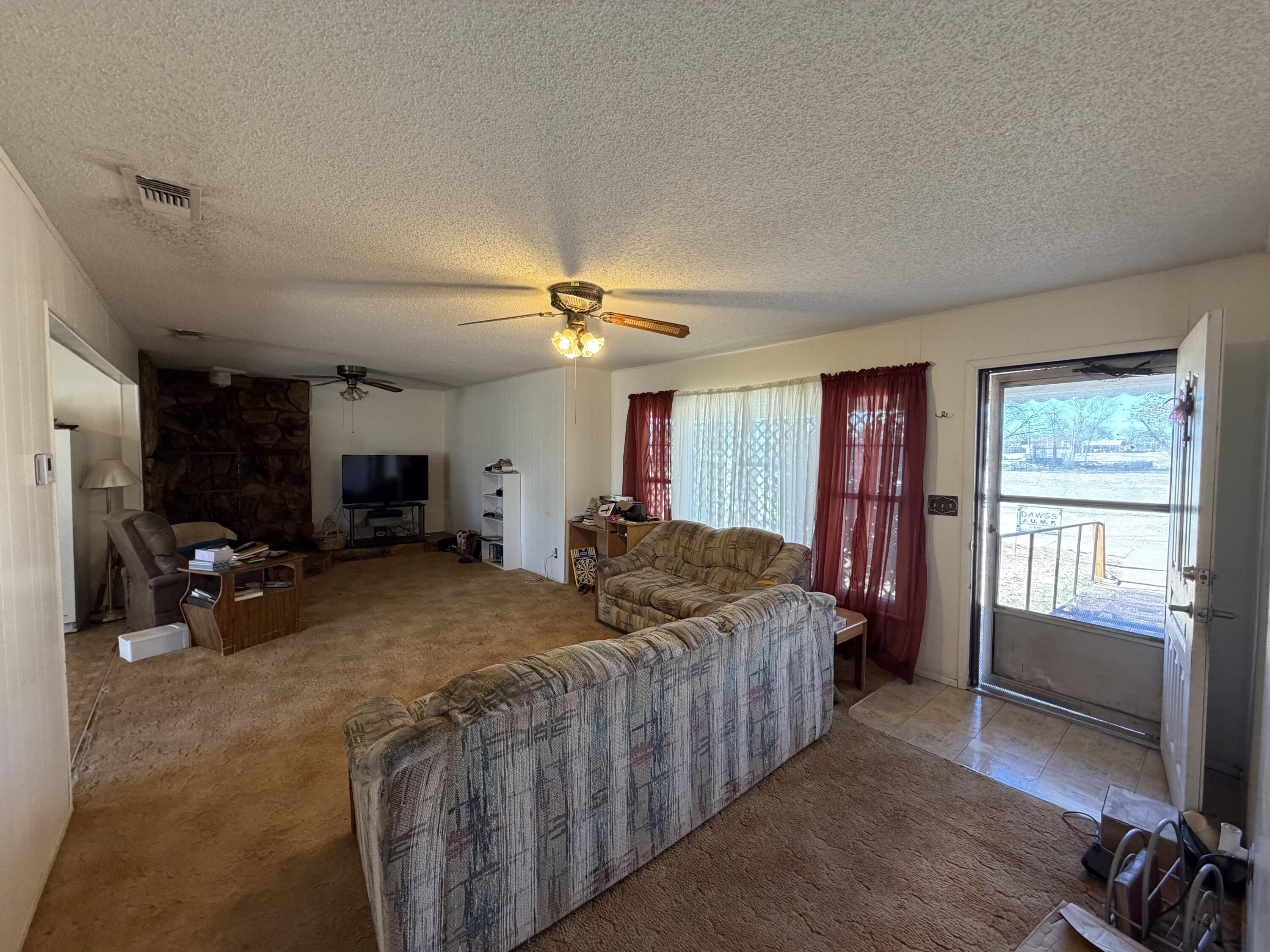 912 Bell Avenue Turkey, TX 79261 - Photo 3 of 12 a bed room with a bed and a tv