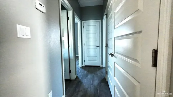 a view of a hallway with wooden floor
