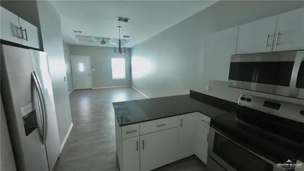 a kitchen with a refrigerator and a sink