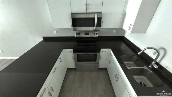 a kitchen with a sink and a stove top oven