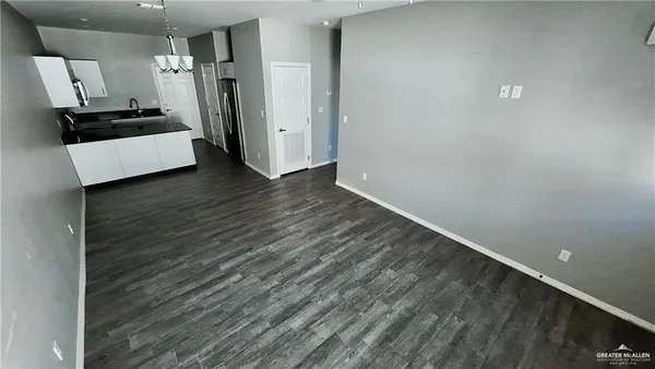 a view of a refrigerator in kitchen and wooden floor