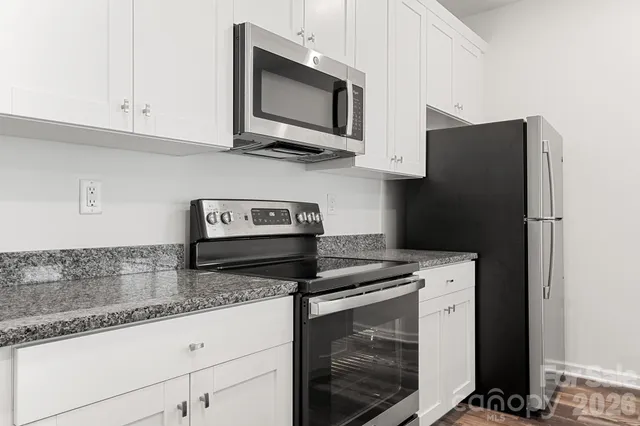 a kitchen with appliances cabinets and a counter top space