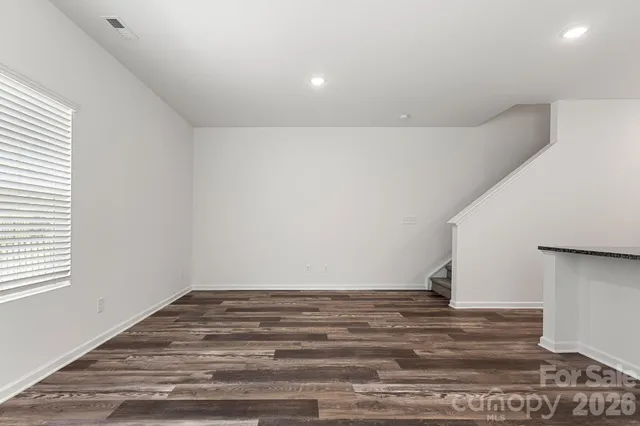 a view of a room with wooden floor
