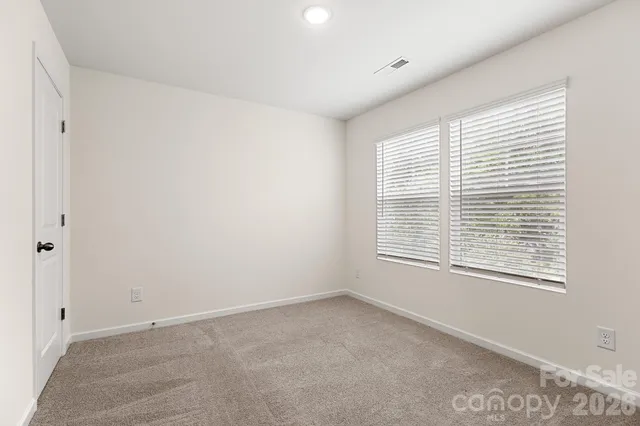 a bathroom with a granite countertop toilet sink and mirror