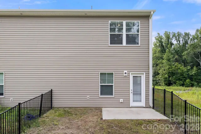a view of a house with backyard and deck
