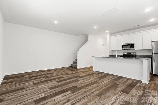 a view of kitchen with microwave and cabinets