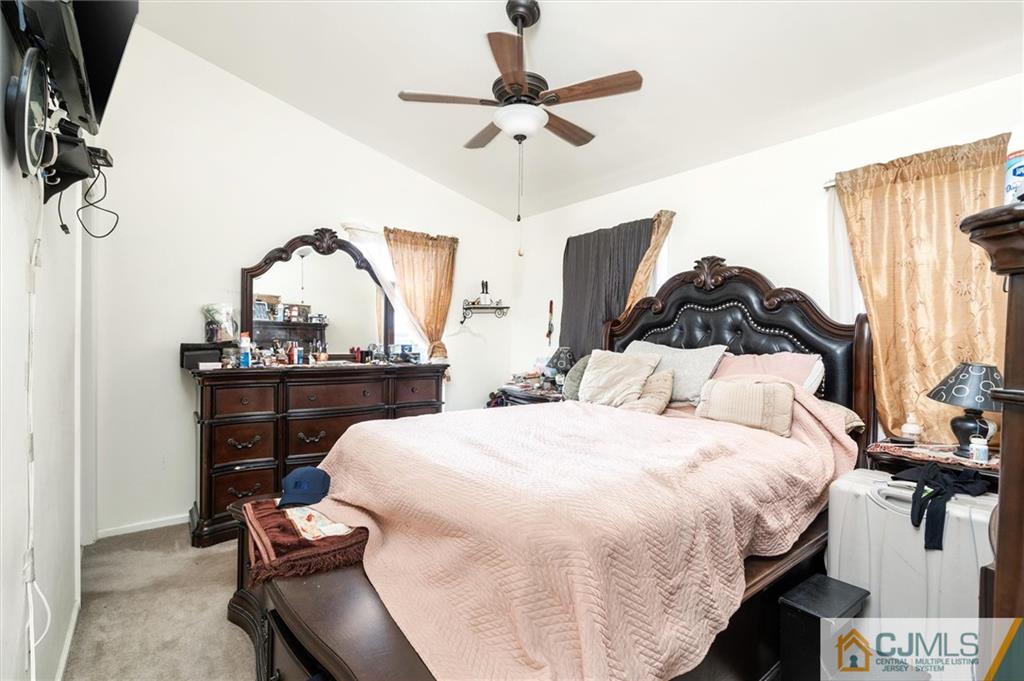 35 Rojewski Way Sayreville, NJ 08859 - Photo 14 of 23 a bedroom with a bed and a chandelier