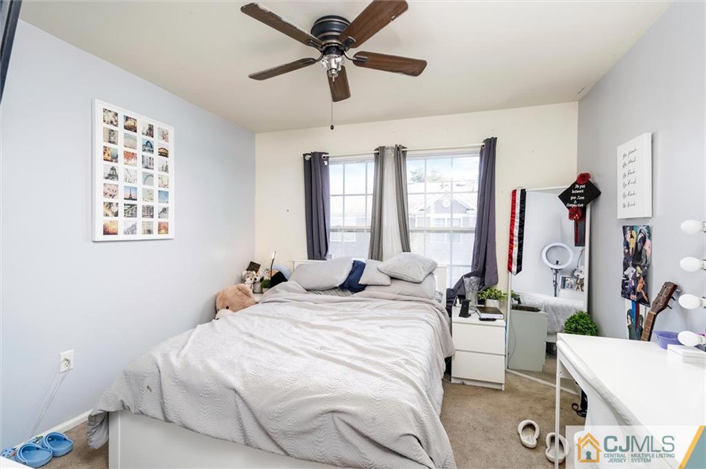 35 Rojewski Way Sayreville, NJ 08859 - Photo 18 of 23 a bedroom with a bed and a chandelier