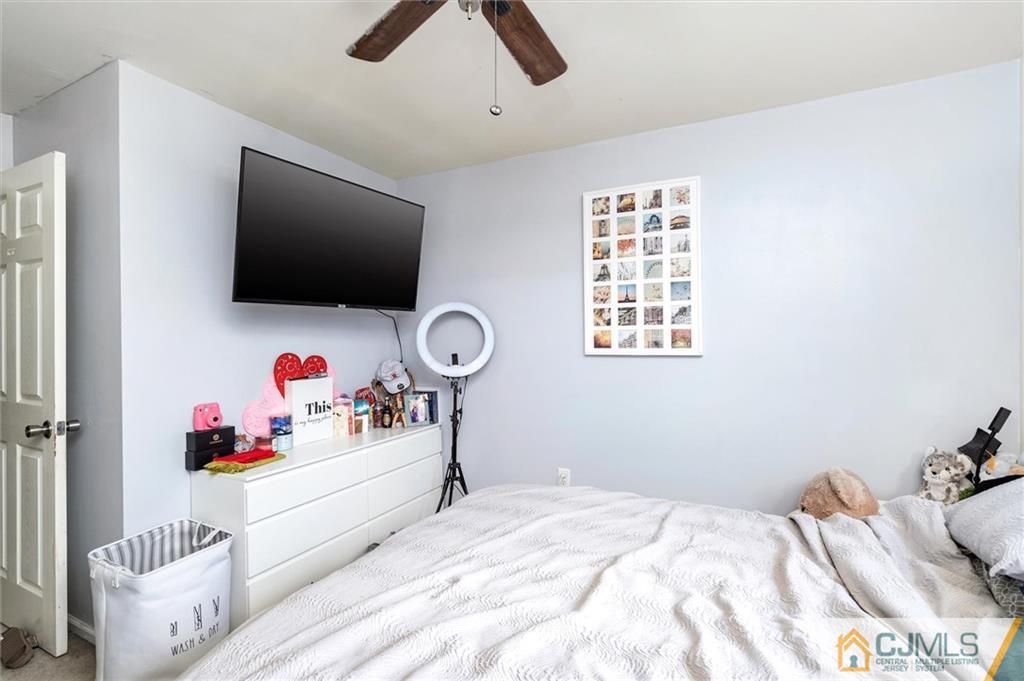 35 Rojewski Way Sayreville, NJ 08859 - Photo 19 of 23 a bedroom with a bed and a flat screen tv