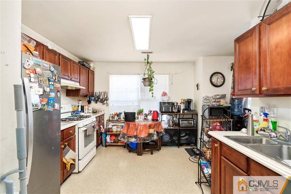 35 Rojewski Way Sayreville, NJ 08859 - Photo 3 of 23 a view of a kitchen with fridge and workspace