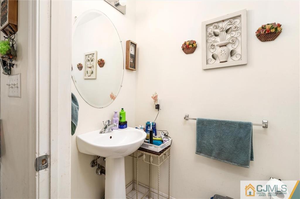 35 Rojewski Way Sayreville, NJ 08859 - Photo 7 of 23 a bathroom with a sink and mirror