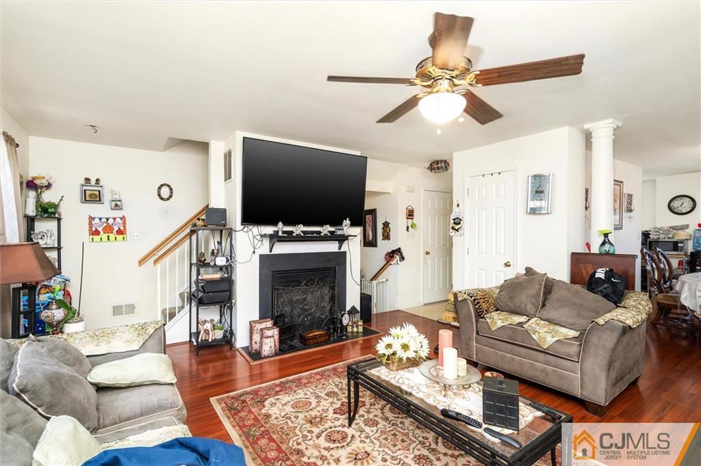 35 Rojewski Way Sayreville, NJ 08859 - Photo 10 of 23 a living room with furniture a flat screen tv and a fireplace