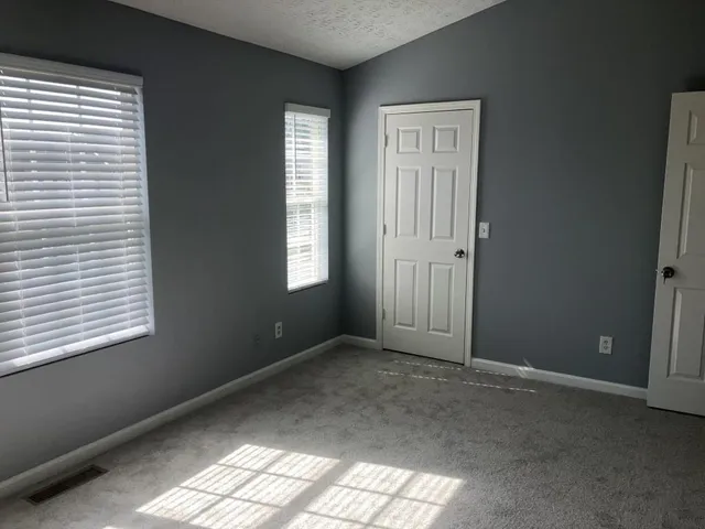 an empty room that has a window in it