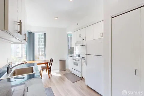 a kitchen with white cabinets and white appliances