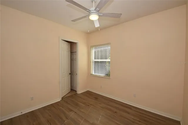 a view of a hallway with a wooden door