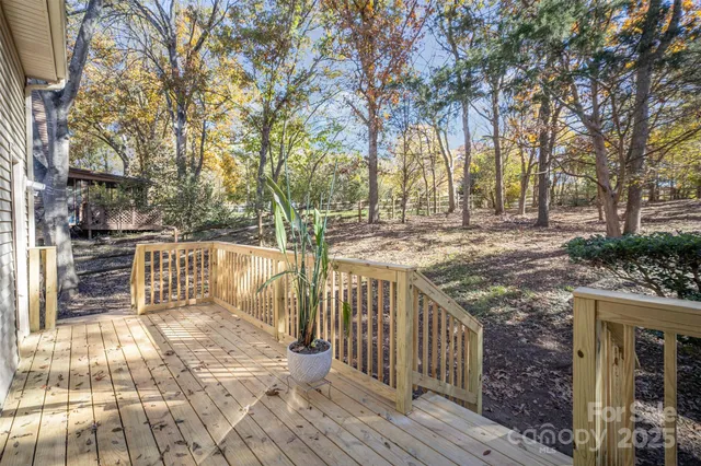 a view of street with wooden deck and trees
