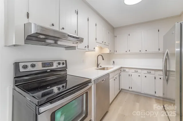 a kitchen with cabinets appliances and a sink