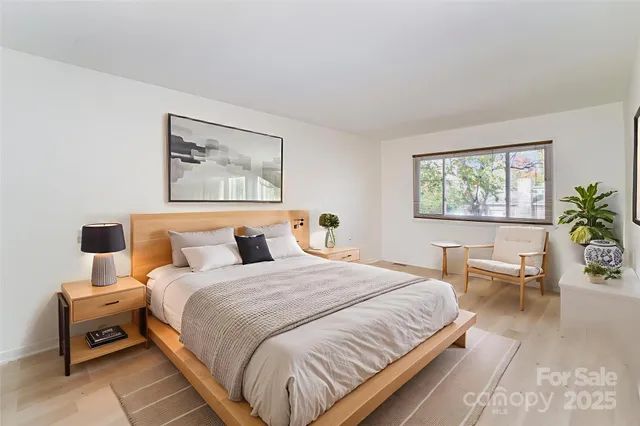 a bedroom with a large bed and a window