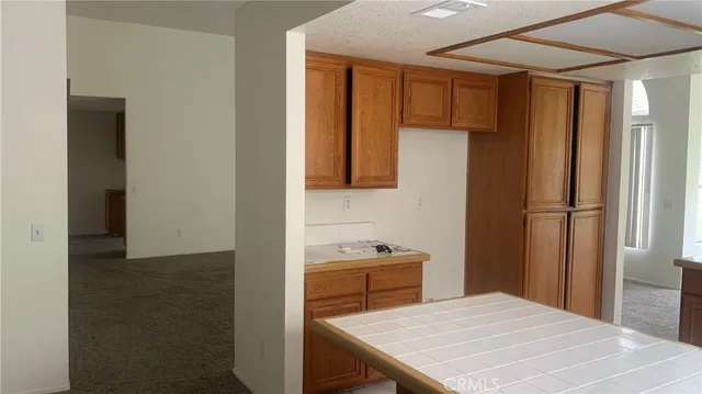 a kitchen with a table and refrigerator