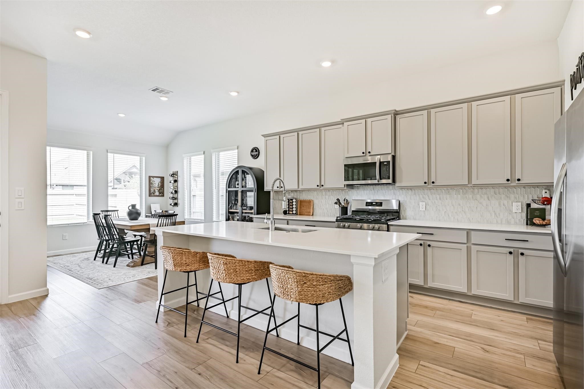 5010 Walnut Grv Lane Manvel, TX 77578 - Photo 18 of 46 a kitchen with stainless steel appliances white cabinets and wooden floor