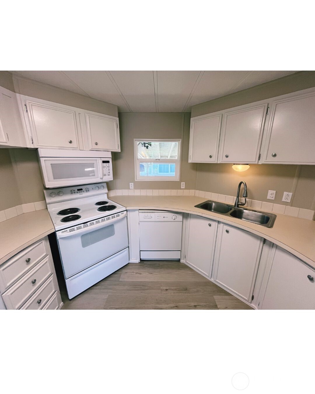 67 Jade Street Walla Walla, WA 99362 - Photo 5 of 21 a kitchen with kitchen island granite countertop a sink cabinets and stainless steel appliances
