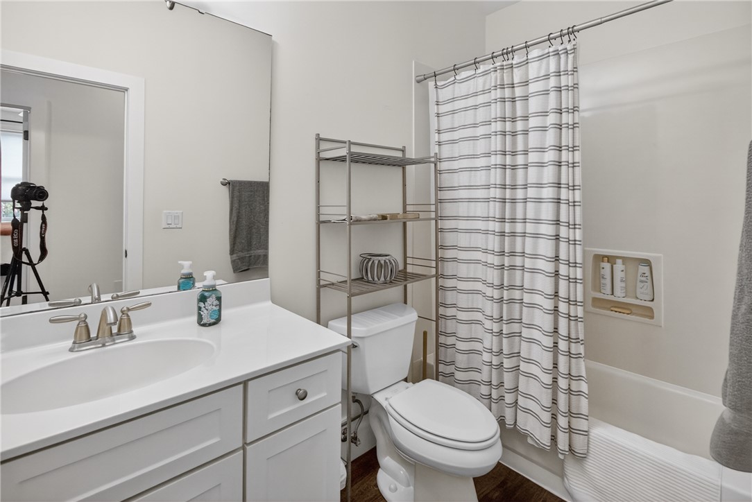 1504 Double Springs Road Townville, SC 29689 - Photo 30 of 41 This bright bathroom features a vanity, mirror, toilet, and a combined shower and tub for daily comfort.