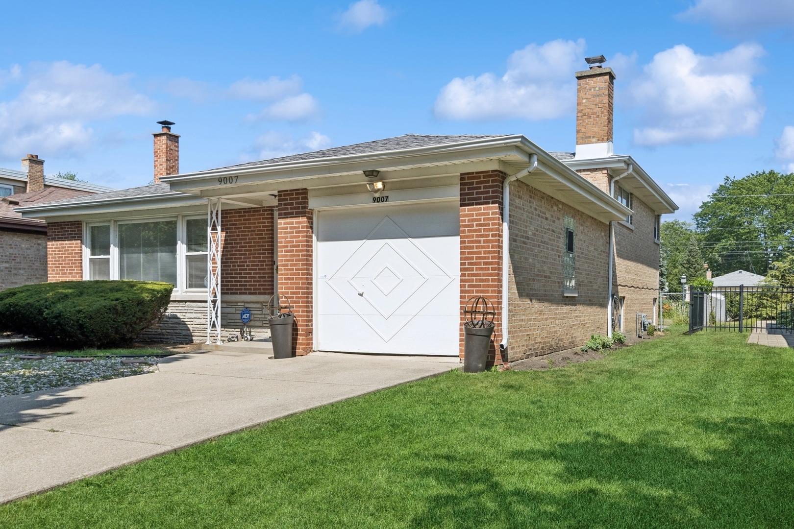 9007 Forestview Road Evanston, IL 60203 - Photo 1 of 29 a front view of a house with a garden and yard