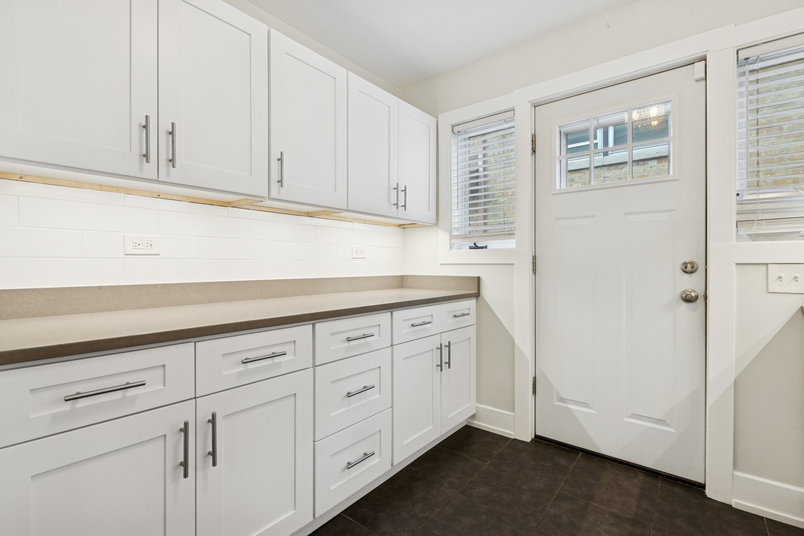 9007 Forestview Road Evanston, IL 60203 - Photo 12 of 29 a kitchen with granite countertop white cabinets and sink