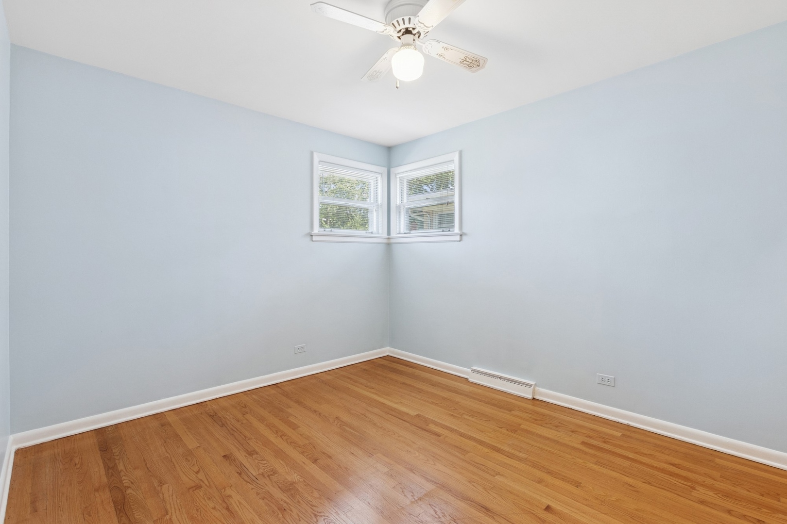 9007 Forestview Road Evanston, IL 60203 - Photo 15 of 29 a view of a room with wooden floor and a ceiling fan