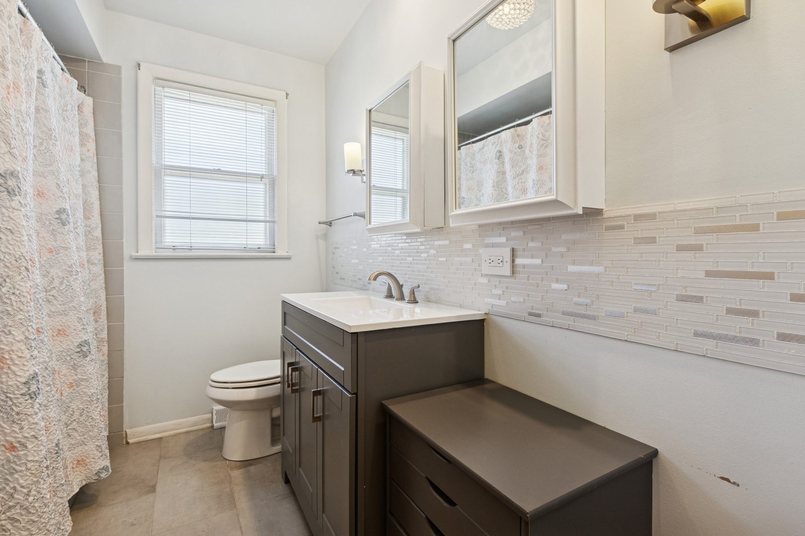 9007 Forestview Road Evanston, IL 60203 - Photo 18 of 29 a bathroom with a sink toilet and mirror