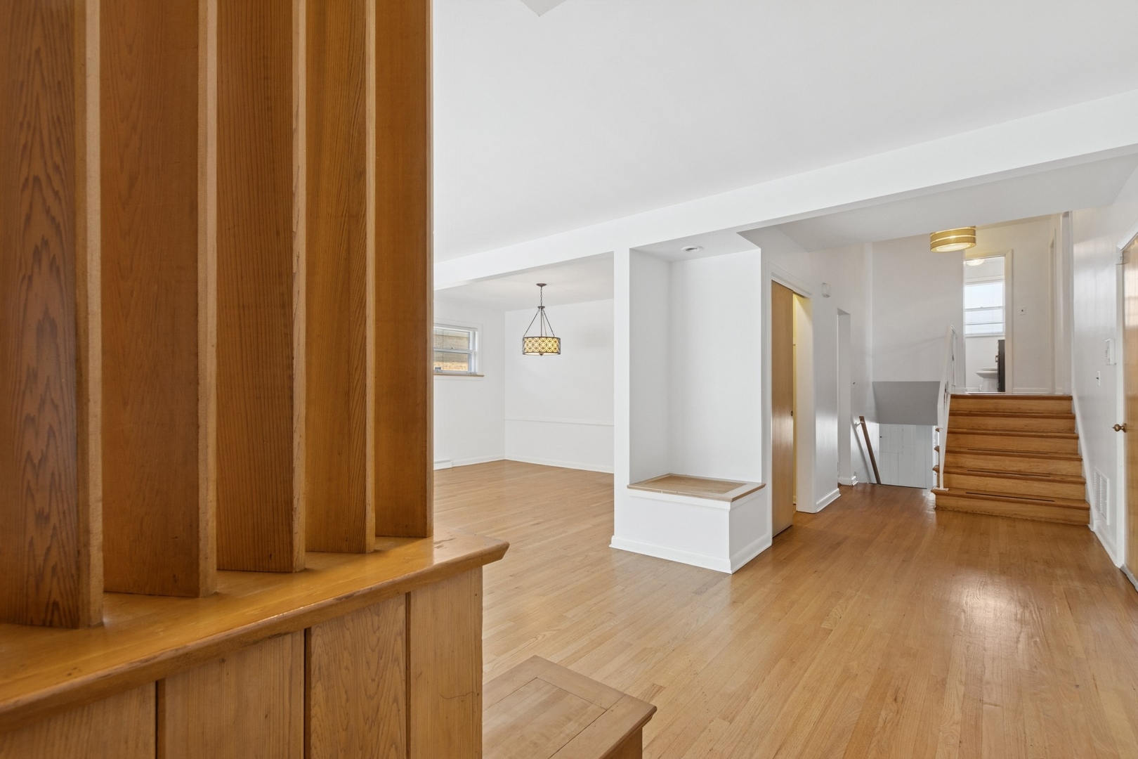 9007 Forestview Road Evanston, IL 60203 - Photo 2 of 29 a view of a hallway with wooden floor and staircase