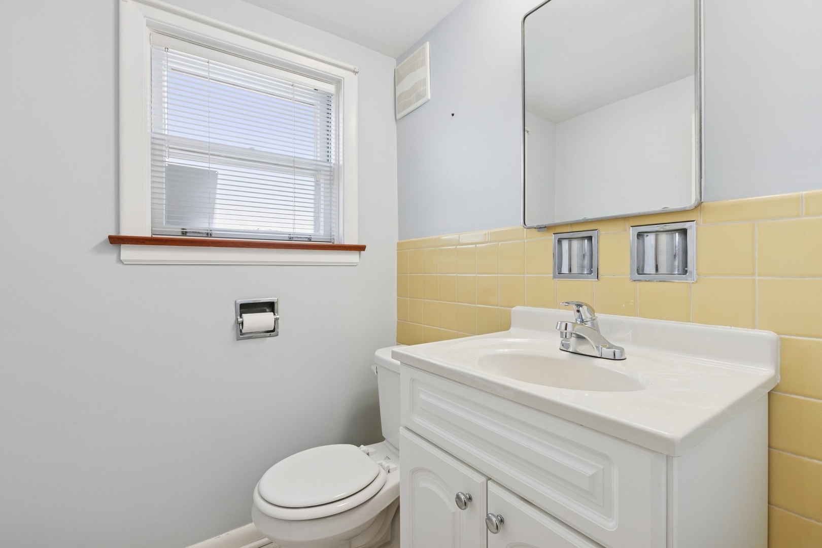 9007 Forestview Road Evanston, IL 60203 - Photo 22 of 29 a bathroom with a sink a toilet and mirror