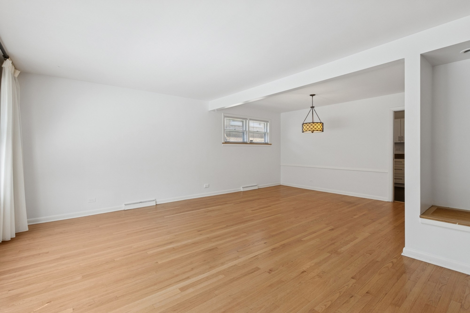 9007 Forestview Road Evanston, IL 60203 - Photo 3 of 29 a view of empty room with wooden floor