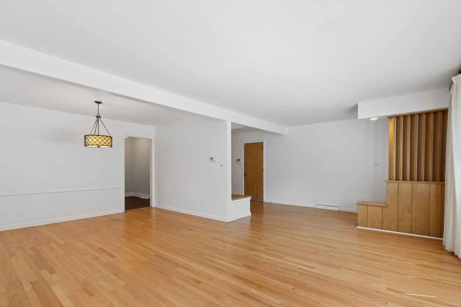 9007 Forestview Road Evanston, IL 60203 - Photo 4 of 29 a view of an empty room with wooden floor