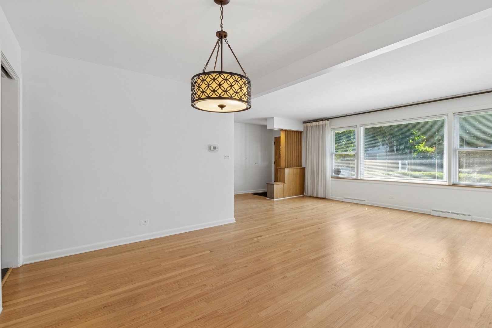 9007 Forestview Road Evanston, IL 60203 - Photo 5 of 29 a view of an empty room with a window and kitchen