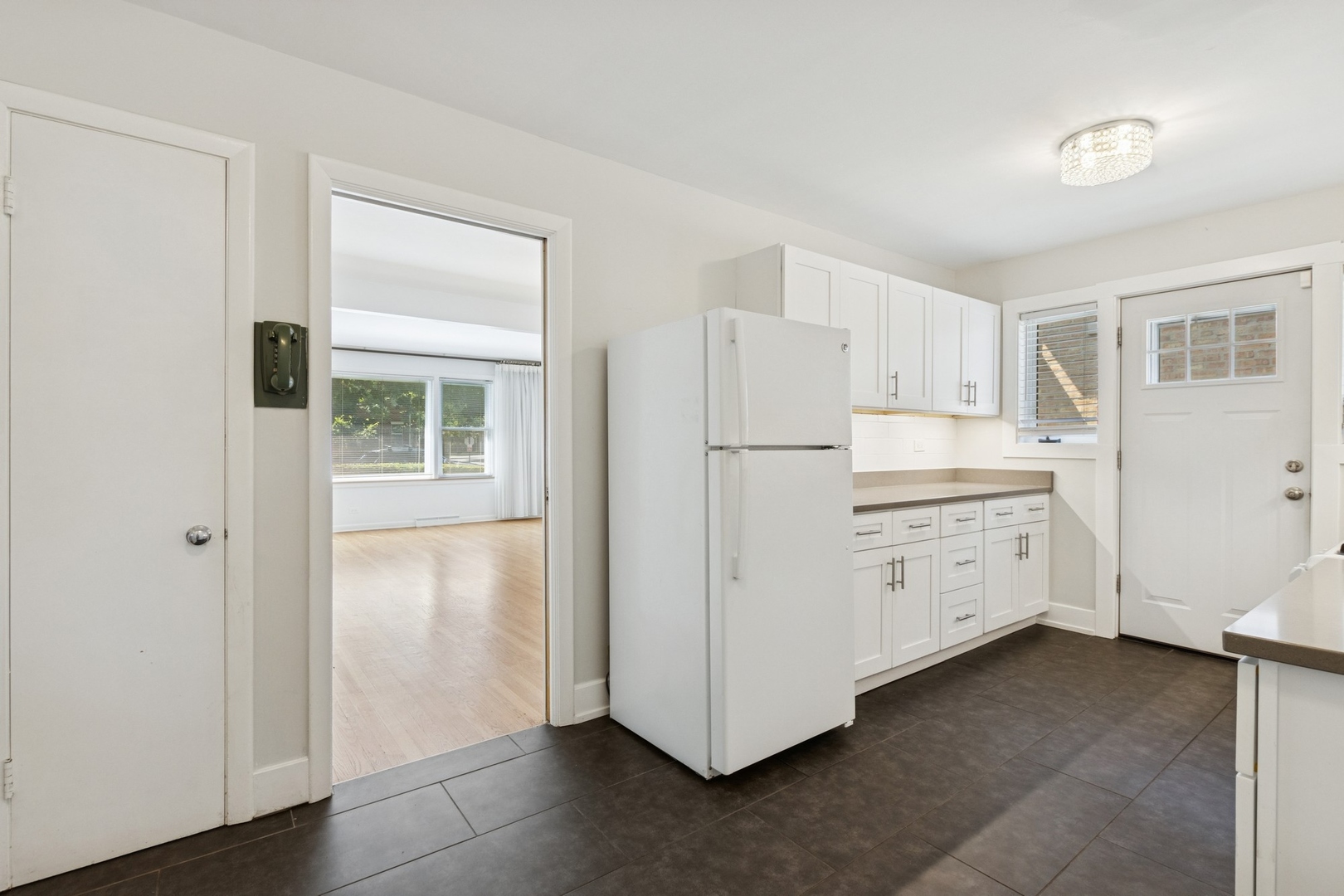 9007 Forestview Road Evanston, IL 60203 - Photo 9 of 29 a kitchen with cabinets a refrigerator and a stove