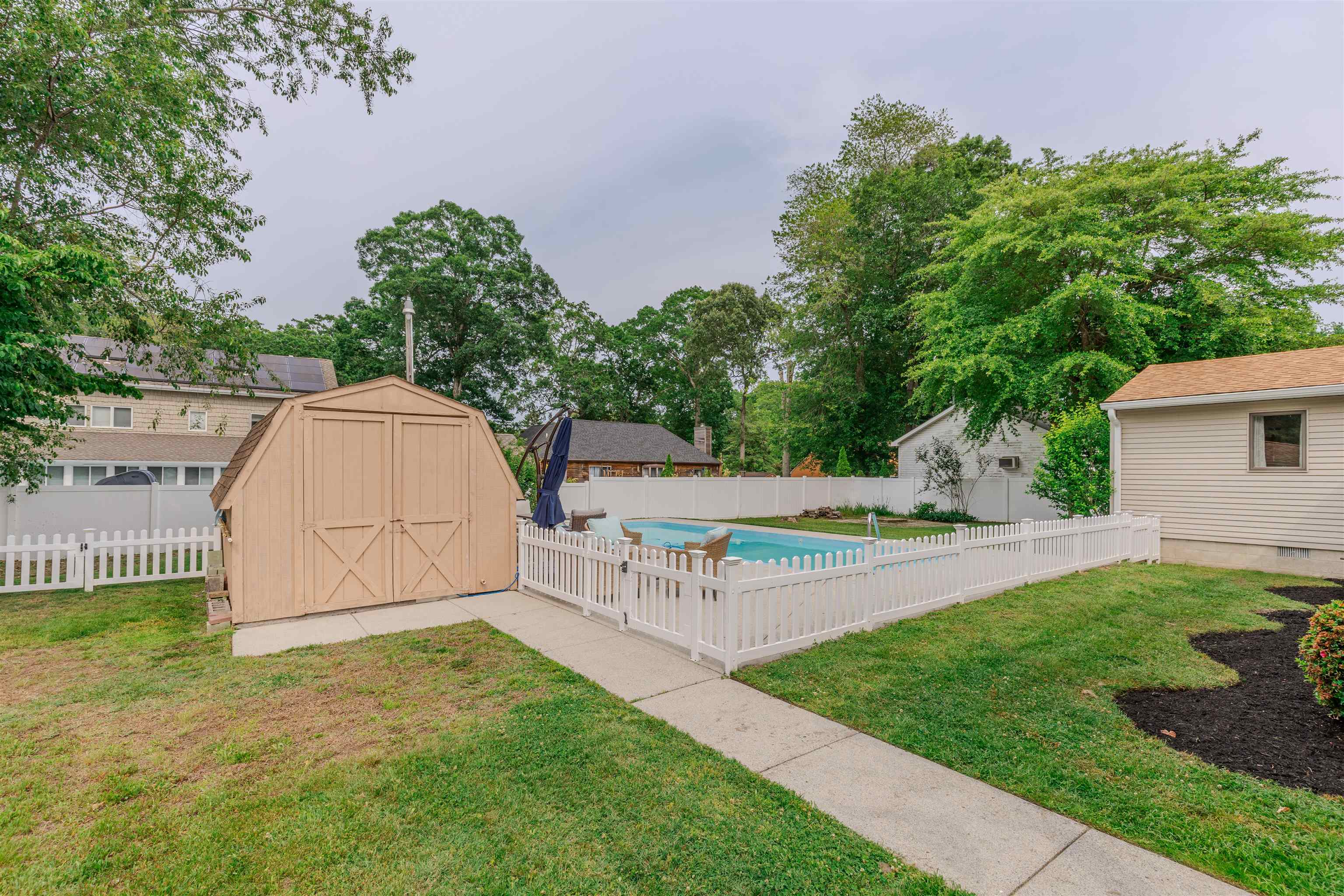 963 Tecumseh Road Erma, NJ 08204 - Photo 27 of 41 a view of backyard with swimming pool and seating space
