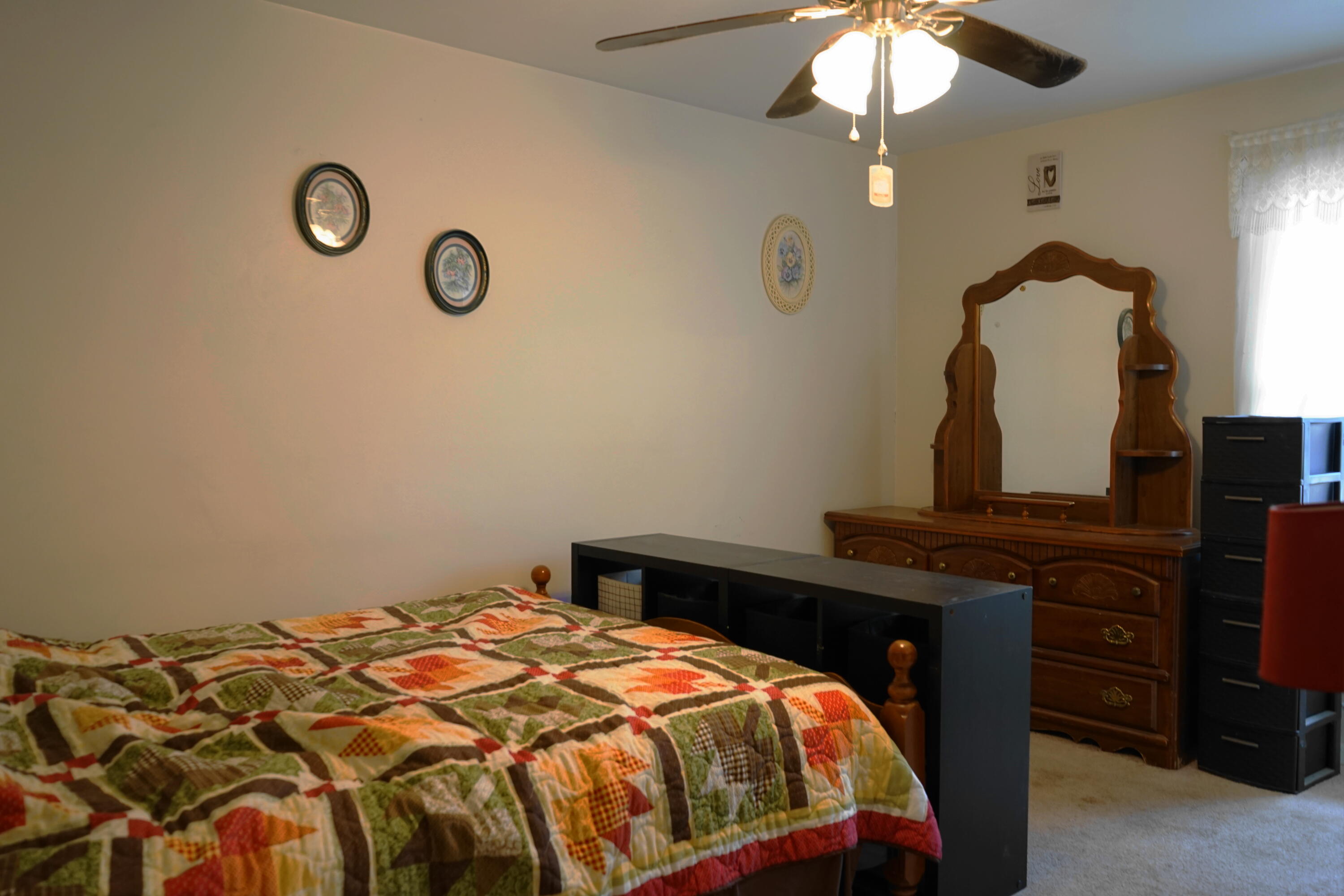 5320 Cove Road Roanoke, VA 24017 - Photo 16 of 30 a bedroom with a bed and a chandelier
