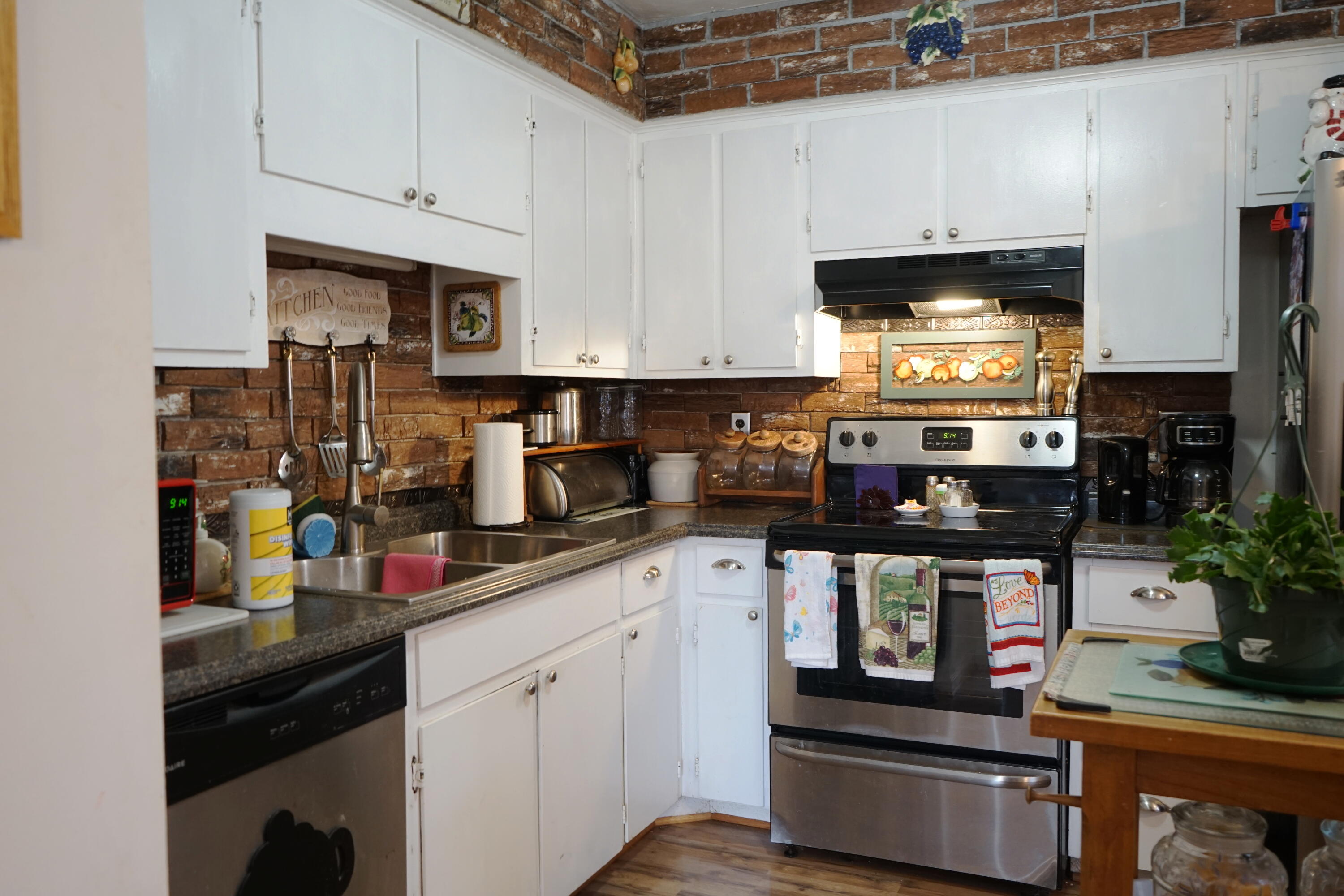 5320 Cove Road Roanoke, VA 24017 - Photo 9 of 30 a kitchen with stainless steel appliances granite countertop a stove a sink and a white cabinets
