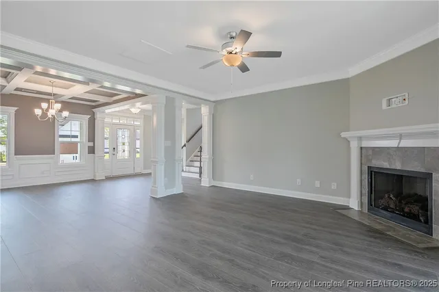 a view of an empty room with exposed radiator and fireplace