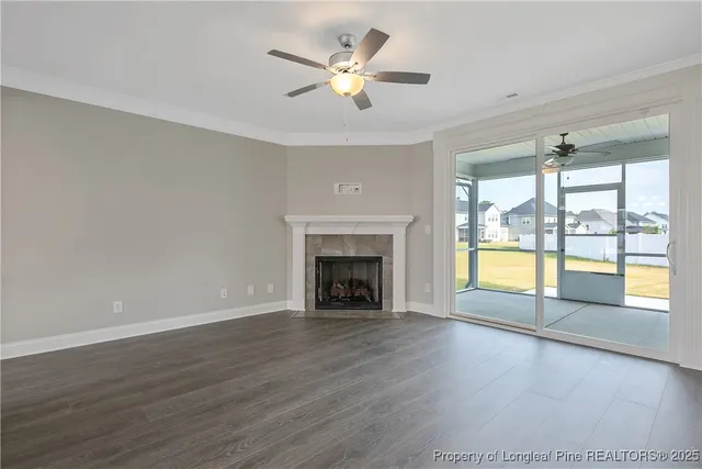 wooden floor fireplace and windows in an empty room