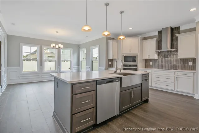 a kitchen with stainless steel appliances kitchen island a large island in the center